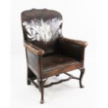 An 18th century boarded oak framed armchair, now with brass studded leather upholstery, with