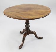 A George III circular mahogany tripod table, with birdcage movement, acanthus carved baluster stem