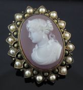 A Victorian gold and split pearl mounted hardstone cameo locket brooch, carved with the bust of a