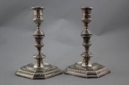 A pair of plated candlesticks, in George II style, with multi knopped gadrooned stems and