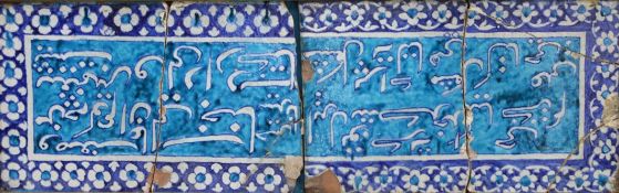 Two large framed Islamic pottery calligraphic tiles, with inscriptions on a turquoise ground with