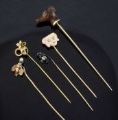 Five assorted early 20th century stick pins, including a French 18ct gold and chalcedony dog's