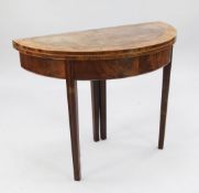 A George III mahogany, satinwood and rosewood banded demi lune folding card table, with moulded