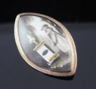 A Regency gold mourning pendant brooch, of navette shape, with painted ivory panel depicting a young