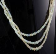 A 1960's triple strand graduated opal bead necklace, with gem set 9ct gold clasp, 16.5in.