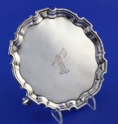 A George II silver waiter, of shaped circular form, with engraved armorial and three scroll feet,