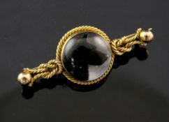 An 18ct gold Essex crystal bar brooch, with rope twist mount and decorated with the head of a