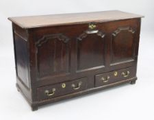 A large 18th century oak mule chest, the front with three fielded panels above two base drawers with