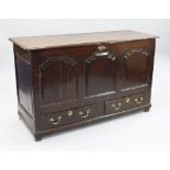 A large 18th century oak mule chest, the front with three fielded panels above two base drawers with