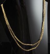 A 9ct gold pierced fancy link guard chain, 62in, 35 grams.