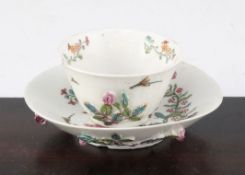 An unusual English soft paste porcelain polychrome teabowl and saucer, possibly Longton Hall c.