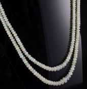 A double strand graduated opal bead necklace, with 14ct gold and coral set oval clasp, 18in.