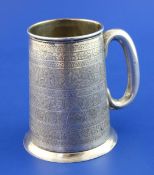 An early 20th century Egyptian 800 standard silver mug, of tapering form, with engraved bands of