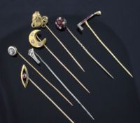 Seven early 20th century assorted gem set stick pins, including French 18ct gold riding crop, a