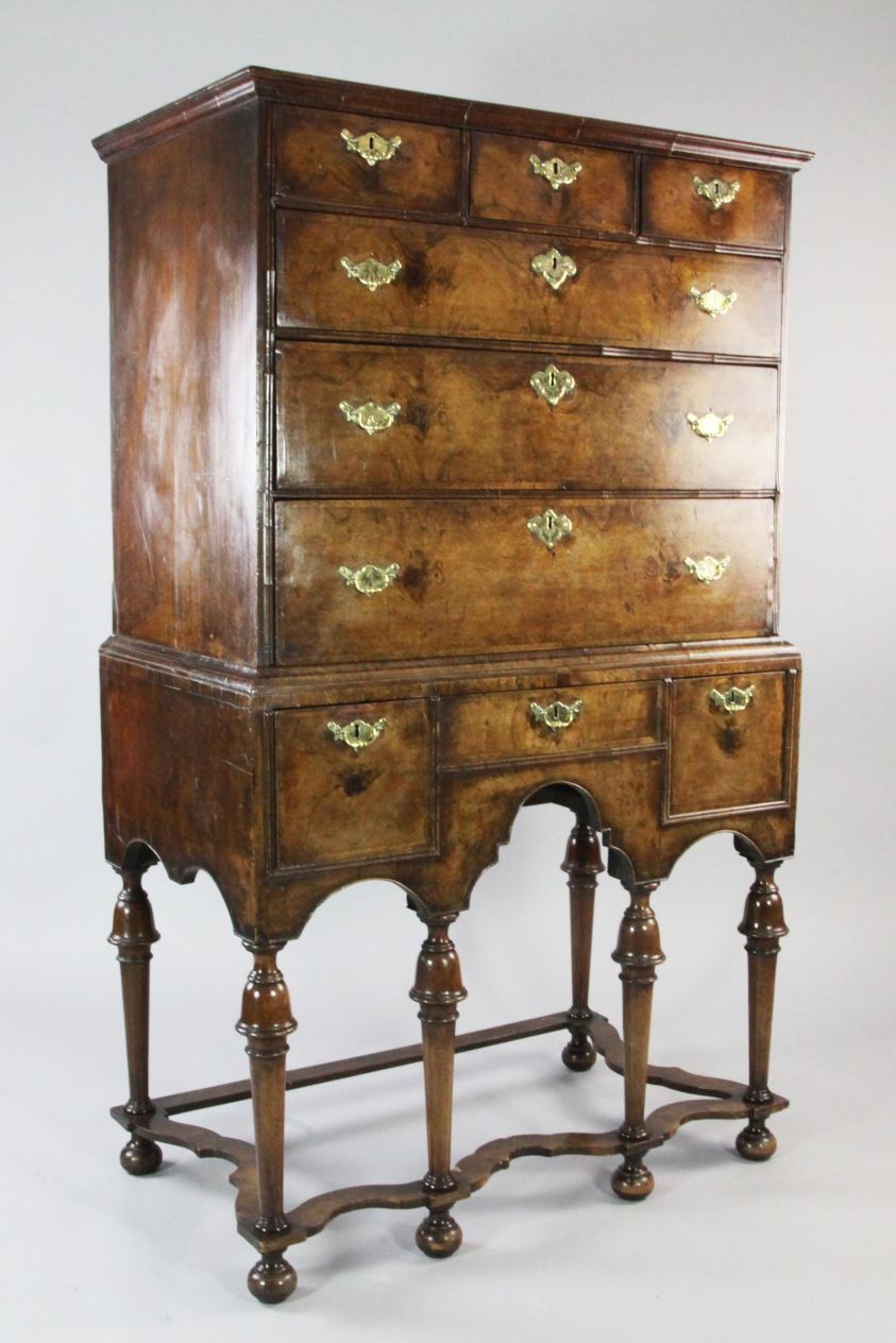 An early 18th century walnut chest on stand, fitted three small drawers above three longer