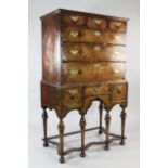 An early 18th century walnut chest on stand, fitted three small drawers above three longer