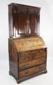 A George II yew wood bureau bookcase, with a pair of fielded panelled doors between quarter side