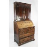 A George II yew wood bureau bookcase, with a pair of fielded panelled doors between quarter side