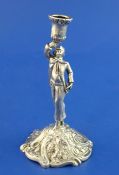 An early George III cast silver figural taperstick, modelled as a gentleman with raised arm