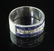 A platinum, sapphire and diamond channel set triple band half hoop ring, with reeded shank, size U.