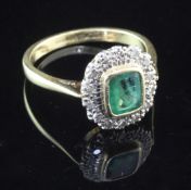 A 1950's? 18ct gold, emerald and diamond cluster ring, size Q.