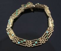 A gold and turquoise set gate link bracelet, with safety chain, (four stones missing), 7in approx.