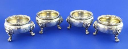 A set of four Victorian silver bun shaped salts, with lion mask knees, on claw and ball feet, John