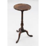 A George III mahogany tripod wine table, with circular dished top, on baluster turned column with