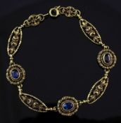 An early 20th century French 18ct gold blue doublet set bracelet, with pierced foliate oval links