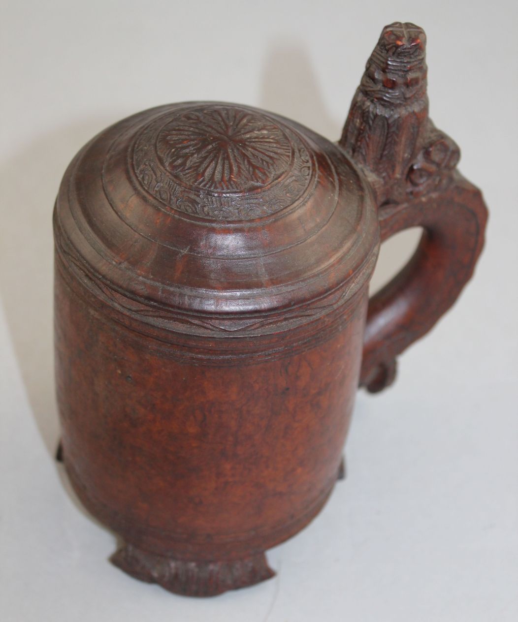 A 19th century Norwegian birch wood peg tankard, with carved thumb piece and domed lid, with - Image 4 of 5