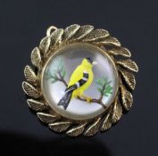 A mid 20th century 14ct gold Essex crystal circular pendant brooch, decorated with a Goldfinch? on a