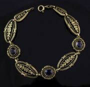 An early 20th century French 18ct gold and synthetic sapphire bracelet, with pierced foliate links