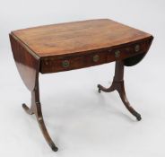 An early 19th century oval crossbanded mahogany sofa table, with single drawer and dummy drawer