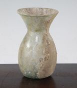 An Islamic glass vase, c.9th century A.D., of ovoid form with a flared neck, some mineral