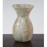 An Islamic glass vase, c.9th century A.D., of ovoid form with a flared neck, some mineral