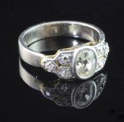 A 1960's 18ct white gold and diamond ring, with central oval cut stone and diamond set shoulders,