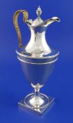 A George III silver Adam style hot water jug, with engraved armorial beaded borders and rattan