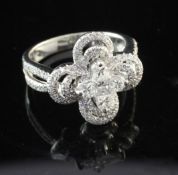 A modern 18ct white gold and diamond cluster dress ring, of pierced quatrefoil design, set with