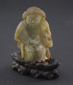 A Chinese celadon and russet skin jade figure of a fisherman, 18th / 19th century, the figure