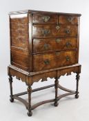 An 18th century walnut featherbanded chest on stand, with two short and three long graduated