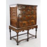 An 18th century walnut featherbanded chest on stand, with two short and three long graduated