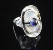 A stylish 14ct white gold, rock crystal, diamond and cabochon sapphire set dress ring, of oval form,