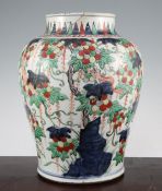 A Chinese wucai baluster jar, 17th century, painted with tree shrews amid fruiting branches and