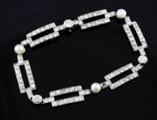 An early 20th century French white gold, cultured pearl and diamond set bracelet, with open