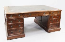 A Victorian mahogany partner's pedestal desk, with gilt tooled green leather writing skiver above an