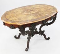 A Victorian walnut oval centre table, of serpentine outline, with central marquetry inlaid oval