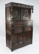 A 17th century carved oak court cupboard, fitted with two doors above a pair of cupboard doors