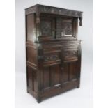 A 17th century carved oak court cupboard, fitted with two doors above a pair of cupboard doors