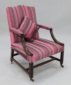 A George III mahogany 'Gainsborough' chair, having blind-fret carved arms and chamfered legs, with X