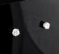 A pair of 18ct gold and solitaire diamond ear studs, each round cut stone weighing approximately 0.